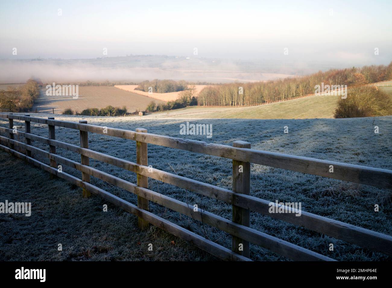 A wooden fence and view on a frosty winter`s morning, Staverton, Northamptonshire, England, UK Stock Photo